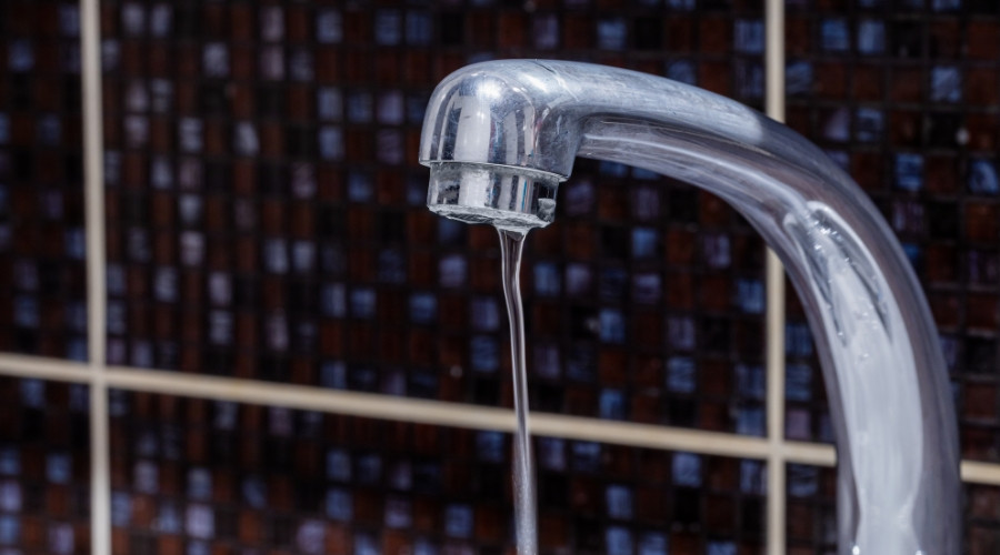 Chrome faucet with slow water flow illustrating low water pressure issues.